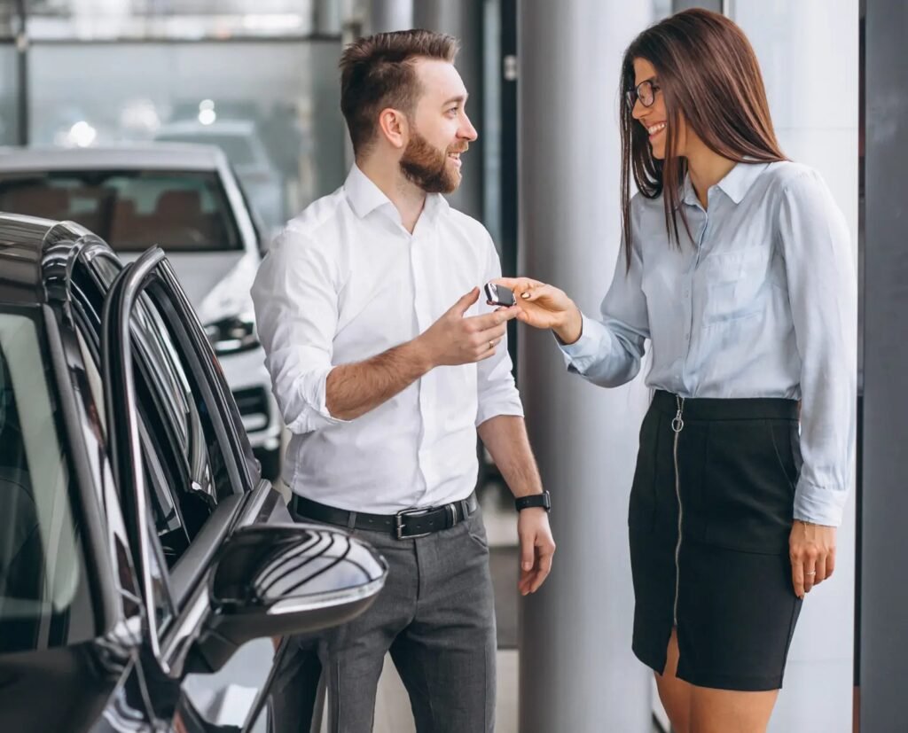 Salesman and woman looking for a car in a car showroom